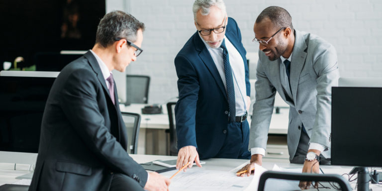 Businessmen discussing new business strategy on meeting in an office, Caber Hill Advisors