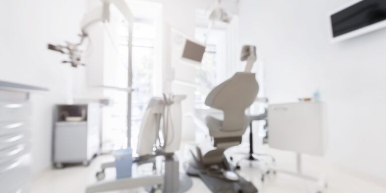 Blurred image of new modern dental clinic office Blurred photo of modern dental clinic. Dentistry, stomatology, medicine medical equipment concept, free space