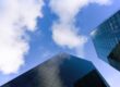 Two glass skyscrapers seen from below